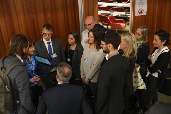 Delegates huddle during the Stockholm Convention Listing Contact Group