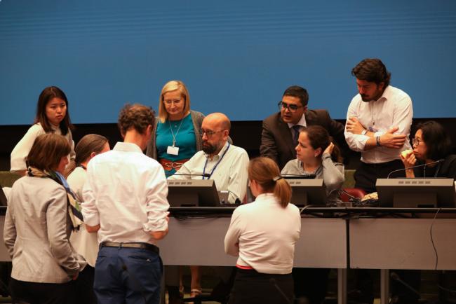 Delegates huddle with the Co-Chairs during the Basel Convention Technical Matters Contact Group