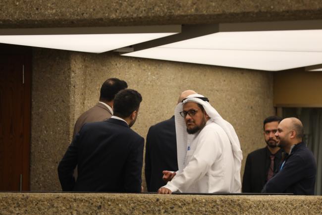 Delegates from Saudi Arabia consult in the corridors