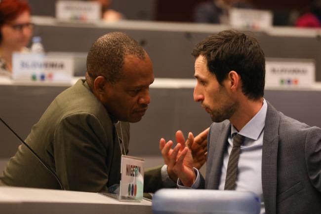 Delegates from Nigeria and Switzerland consult