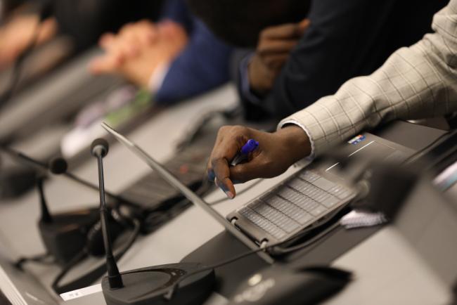 Delegate touches laptop