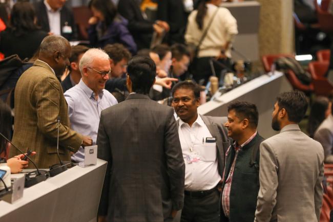 Delegates meet informally between sessions