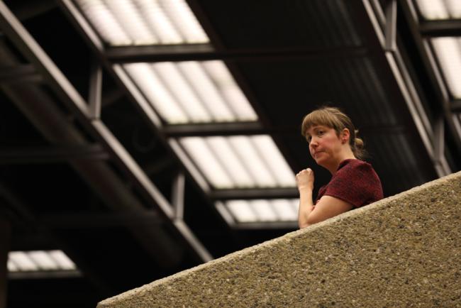 A delegate watches the proceedings from the gallery