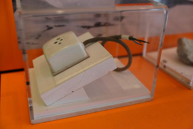 Various items containing asbestos are displayed around the venue