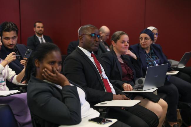 Delegates listen during the session