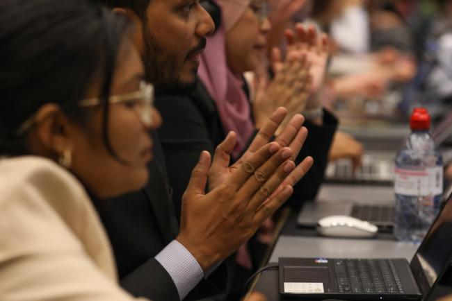 Delegates applaud the adoption of various decisions under the Basel Convention