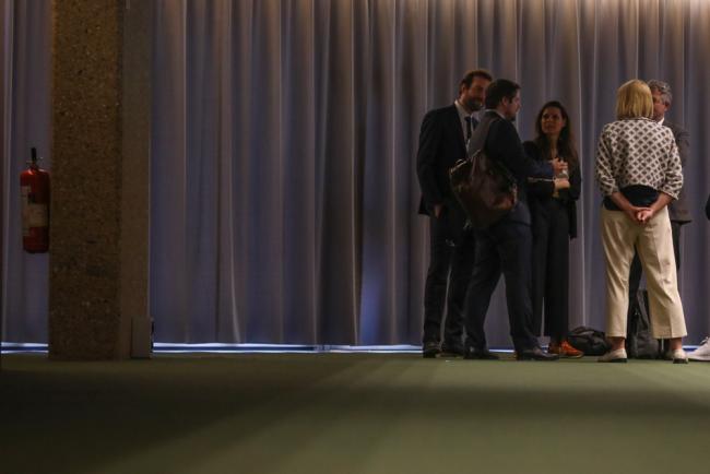 Delegates consult in the corridors