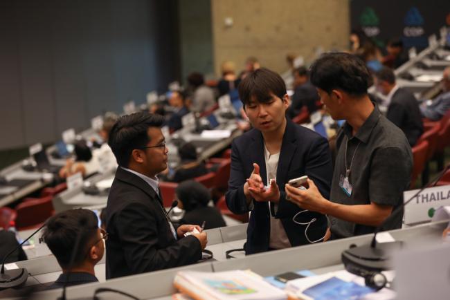 Delegates from the Philippines and the Republic of Korea consult
