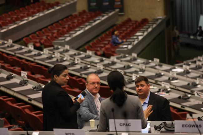 Delegates meet before the start of plenary