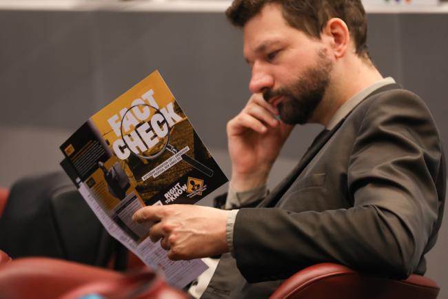 Delegates read materials between sessions