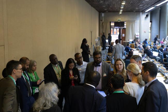 Delegates convene in a huddle 