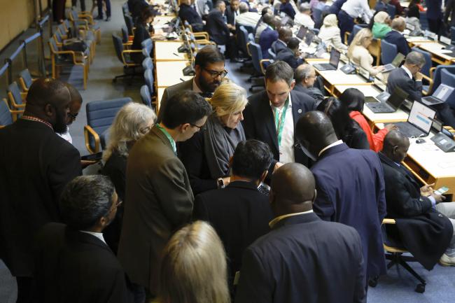 Delegates convene in a huddle