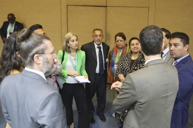 Delegates convene in a huddle 