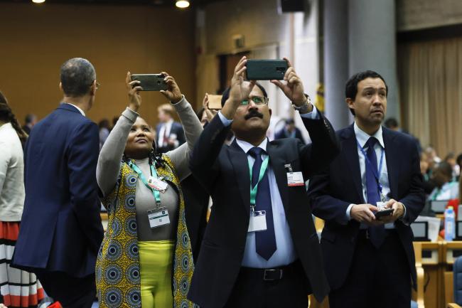 Delegates taking a photo of the slide 