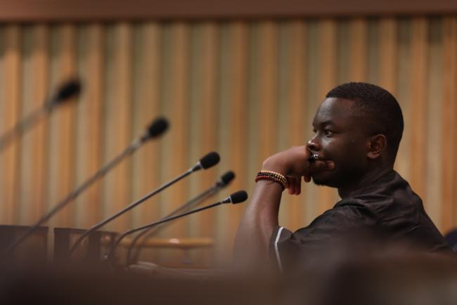 A youth delegate listens during the session