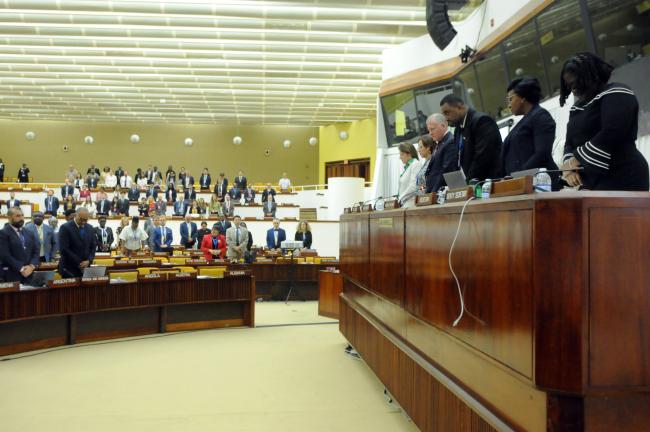 Council members during a moment of silence at the beginning of the session