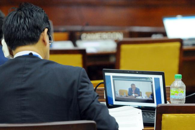 A participant follows the proceedings online