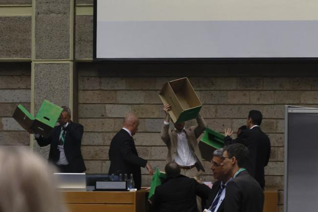 Tellers showing the voting boxes being empty of ballots