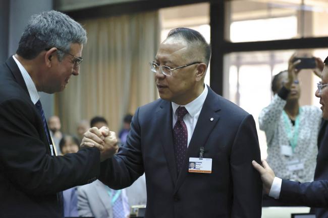 Zhang Xiaoye, China, is being congratulated for his election as WGI Co-Chair