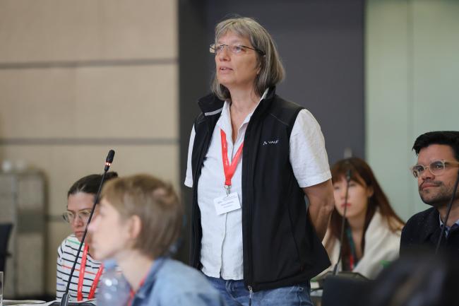 A stakeholder posing a question to the speakers 