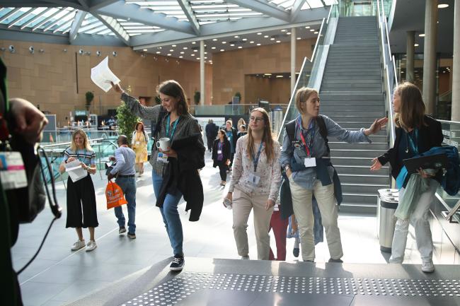 Delegates getting the ENB daily report before entering to the morning plenary