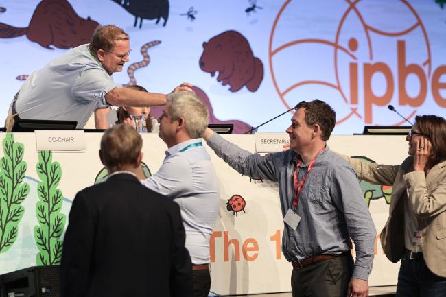 Douglas Beard, Co-Chair of Working Group 2, being congratulated by the delegates at the end of the session 