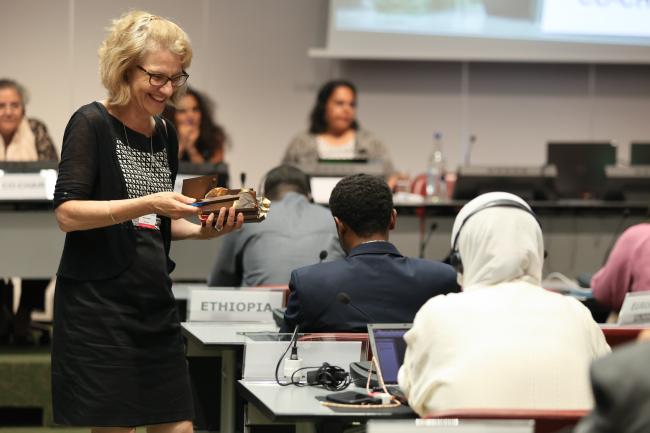 Martine Rohn-Brossard, Co-Chair, Switzerland, distributing chocolates to the delegates to stay energised during the afternoon plenary