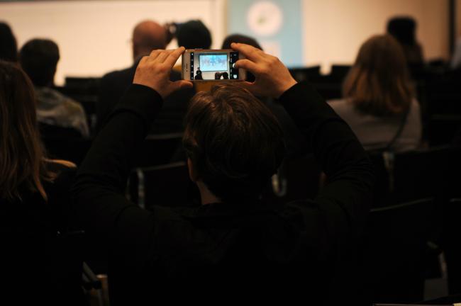 A participant takes a photo of the presentation by Deepali Sinha Ketriwal, E[co]work
