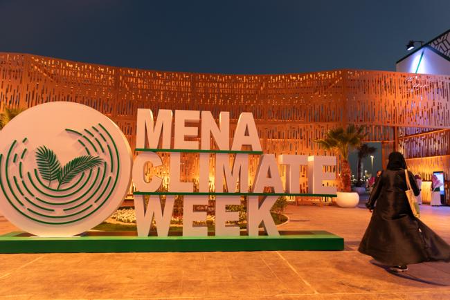 A delegate walks through the venue as the fourth day of MENA Climate Week draws to a close