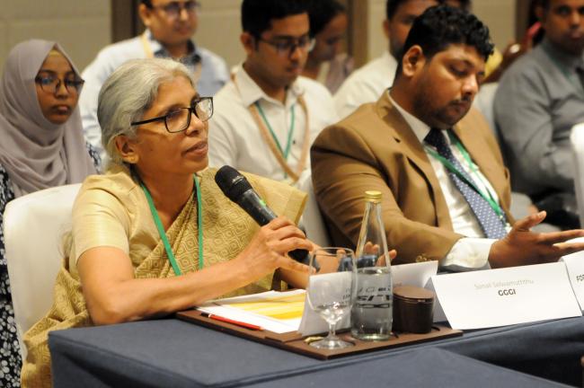 A participant poses a question the panelists