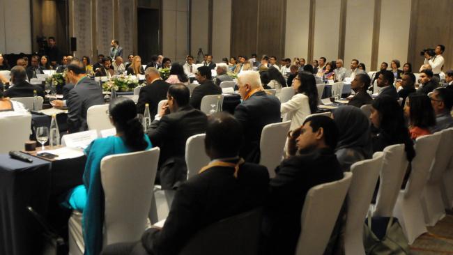 Participants listen to interventions during the opening