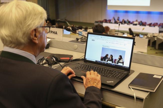 A delegate looks at the Earth Negotiations Bulletin's coverage of COP-5- MinamataCOP5 - 3Nov2023 – Photo.jpg