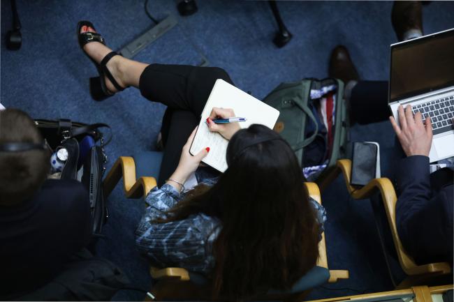 A delegate taking notes