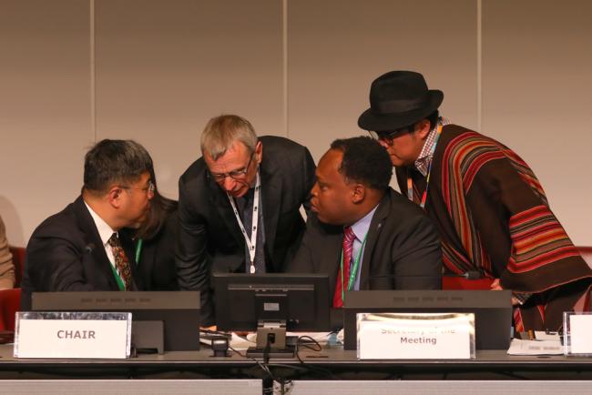 Members of the CBD Secretariat consult on the dais