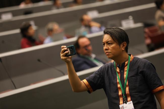 Delegates take photos of the speakers