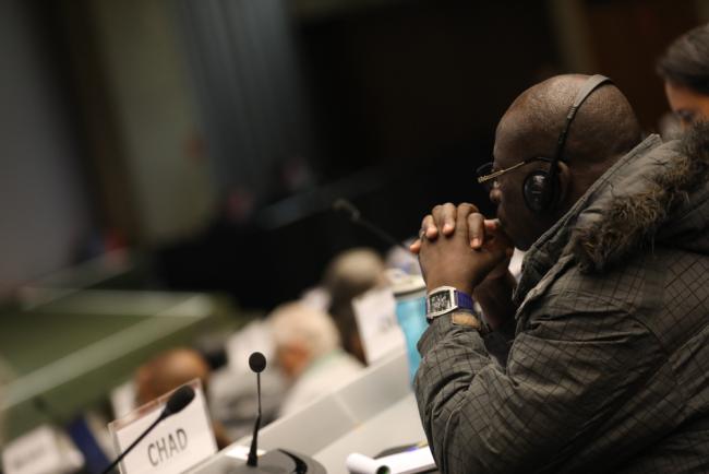 A delegate listens to the discussions