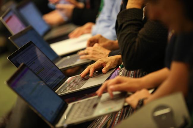 Delegates take notes during the contact group