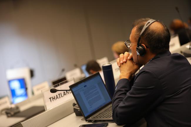 A delegate listens to the discussions