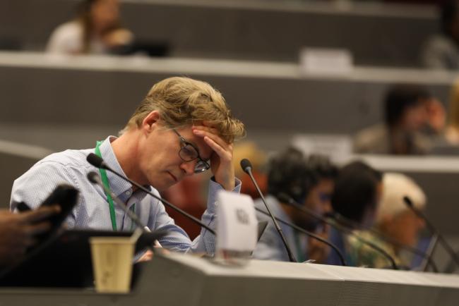 Delegates follow the proceedings