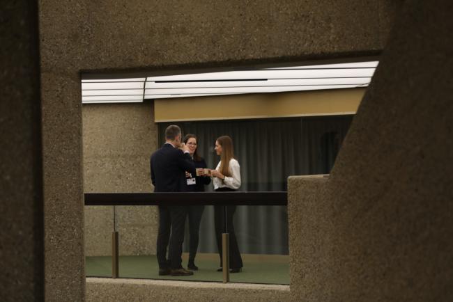 Delegates from Germany speak informally in the corridors