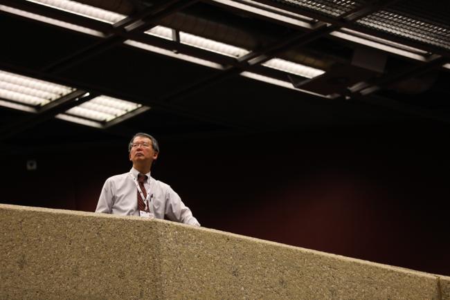 A delegate watches the proceedings from the gallery