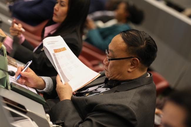 Delegates review the proposals under discussion