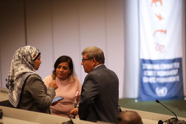 Delegates speak informally at the start of the day