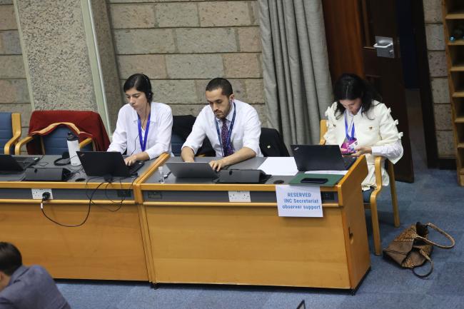 Members of the INC Secretariat taking notes 