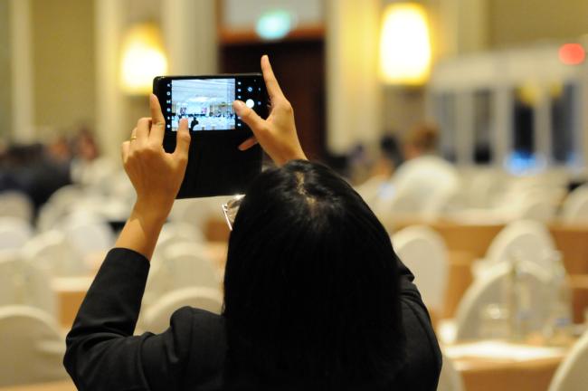 A participant takes a photo of the Council