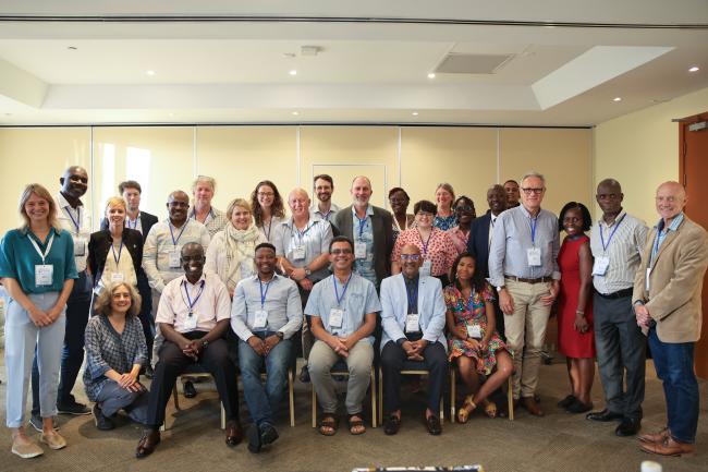 Participants to the Tackling the triple planetary crisis event pose for a family photo