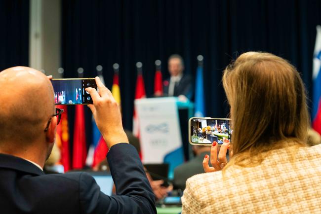 Delegates taking photo during Robert Golob's speech