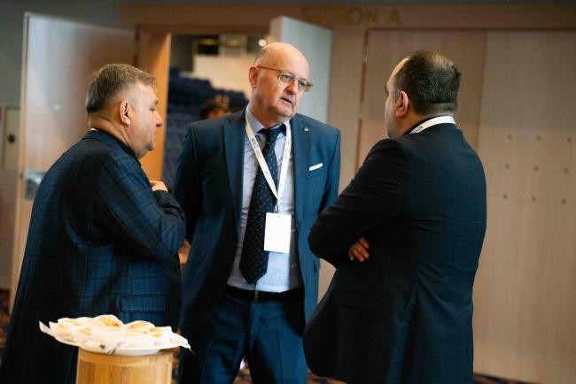 Men speaking in the corridors
