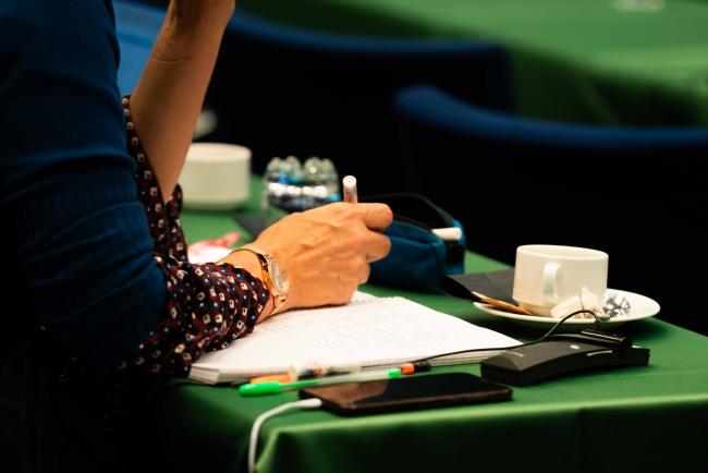 person taking notes during plenary