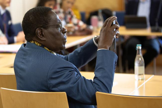 A delegate takes a photo of the panel